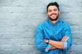 Its a good day to just smile. Cropped portrait of a handsome young man smiling while standing with his arms crossed Royalty Free Stock Photo