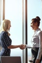 Its good to finally meet you. two young businesswoman shaking hands in their office.