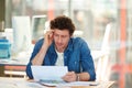 Its got him thinking. A young man working on a digital tablet in the office. Royalty Free Stock Photo