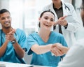 Its great being a part of this team. a young female doctor shaking hands with a colleague at work. Royalty Free Stock Photo