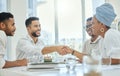 Its great to have you on the team. two young diverse businesspeople shaking hands during a meeting in the boardroom. Royalty Free Stock Photo