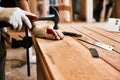 Its hammer time. an unrecognizable carpenter hammering nails on wood inside a workshop.