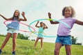 Its hard not to be happy when youre hula hooping. a group of young girls playing with hula hoops in the park. Royalty Free Stock Photo