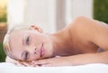 Its here that I let my worries wash away. A gorgeous blond woman looking at you while lying on a spa bed. Royalty Free Stock Photo