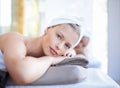 Its here that I let my worries wash away. A gorgeous blond woman looking at you while lying on a spa bed. Royalty Free Stock Photo