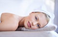 Its here that I let my worries wash away. A gorgeous blond woman looking at you while lying on a spa bed. Royalty Free Stock Photo