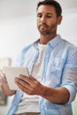 Its his office away from the office. a businessman using his digital tablet at home. Royalty Free Stock Photo