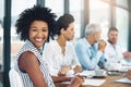 Its an honour to be a part of this team. Portrait of a young businesswoman sitting in a meeting with her colleagues in Royalty Free Stock Photo