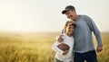 Its important to set aside time for outdoor play. father and son playing football on an open field.