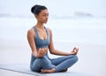 Its about inner peace. Full length shot of an attractive young woman meditating while practicing yoga on the beach. Royalty Free Stock Photo