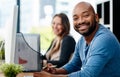 Its about job satisfaction. Portrait of a young male designer working at his desk in the office. Royalty Free Stock Photo