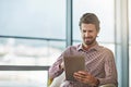 Its like his own portable office. a handsome young businessman using his tablet in the office. Royalty Free Stock Photo