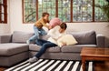 Its the little things that make their childhood fun. a man and his young son having a pillow fight on the sofa at home. Royalty Free Stock Photo