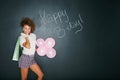 Its my birthday and youre invited. Studio portrait of an attractive young woman holding balloons with the words happy b