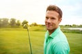 Its my sport of choice. a young man spending the day on a golf course.