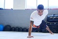 Its my striking arm. Portrait of a young man doing one-handed pushups in the gym. Royalty Free Stock Photo