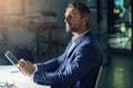 Its never too late for success. a businessman using a digital tablet while woking late at the office. Royalty Free Stock Photo