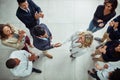 Its a new partnership worth celebrating. High angle shot of two businesspeople shaking hands surrounded by colleagues