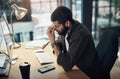 Its not all fun and games being a go getter. a young businessman feeling stressed while working late at night in a Royalty Free Stock Photo