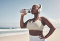 Its not just about exercise, its about your diet too. a woman wearing headphones and drinking water while out for a