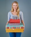 Its obvious why she gets invited to parties. Cropped studio shot of a young woman holding a stack of presents. Royalty Free Stock Photo