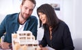 Its really one of a kind. Two architects in working on a model of a house. Royalty Free Stock Photo