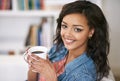 Its one of those laid-back Saturday mornings.... Portrait of a young woman drinking a cup of coffee at home. Royalty Free Stock Photo