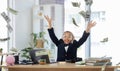 Its raining money. an adorable little girl dressed as a businessperson sitting alone in an office and throwing money. Royalty Free Stock Photo