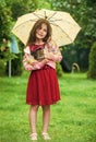 its rainy weather. small girl hold kitten. kid love her pet. human and animals. love and care. fluffy cat in hand of Royalty Free Stock Photo