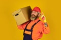 Its Always Saturday. unpacking moving boxes. new house at moving day. Man builder in boilersuit hold boxes. moving to Royalty Free Stock Photo