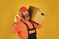 Its Always Saturday. unpacking moving boxes. new house at moving day. Man builder in boilersuit hold boxes. moving to Royalty Free Stock Photo