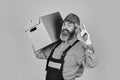 Its Always Saturday. unpacking moving boxes. new house at moving day. Man builder in boilersuit hold boxes. moving to Royalty Free Stock Photo