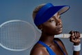 Its the setbacks that help you grow. Studio shot of a sporty young woman posing with a tennis racket against a grey