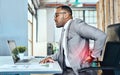 Its a sign of too much stress with little rest. a young businessman suffering with back pain while working in an office. Royalty Free Stock Photo