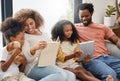 Its storytime. Shot of a young family spending time together and using a digital tablet at home. Royalty Free Stock Photo