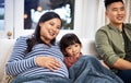 Its their family tradition to watch a movie every weekend together. a family watching television together at home. Royalty Free Stock Photo