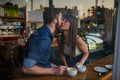 Its their first date. an affectionate young couple kissing while sitting in a coffee shop during a date. Royalty Free Stock Photo