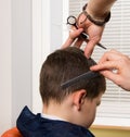 Its time for a new hairstyle. In the hands of a hairdresser there is a comb and scissors. haircut in a hairdressers child