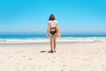 Its about that time for a surf. Rearview shot of a sexy young woman walking towards the ocean with her surfboard. Royalty Free Stock Photo