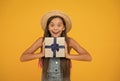 Its time for surprise. Happy girl hold gift yellow background. Surprise box. Surprised look of little child. Birthday Royalty Free Stock Photo