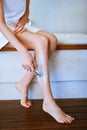 Its time to get smooth. a young woman shaving her legs in the bathroom. Royalty Free Stock Photo