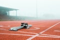 Its time to put your foot down. metal starting blocks standing out on a running track. Royalty Free Stock Photo