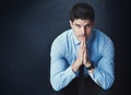 This is it - its time to reach the ultimate. Studio portrait of a young businessman posing against a dark background.