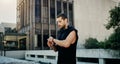 Its time to show yourself what youre capable of. a young man looking at his watch while exercising in the city.