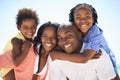 Its times like these you appreciate family. Two parents giving their children a piggyback while on the beach. Royalty Free Stock Photo