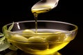 In its various forms, olive oil is poured gracefully into a spoon Royalty Free Stock Photo