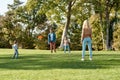 Its the weekend. Enjoy it. Parents playing frisbee with their kids in the park on a sunny day Royalty Free Stock Photo