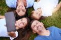 Its a weekend with the family. Portrait of a cheerful family lying on the ground while taking a self portrait together Royalty Free Stock Photo