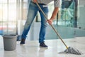 Its a well kept office. Shot of an unrecognizable man mopping the office floor. Royalty Free Stock Photo