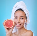 Its about what you put in. Studio portrait of an attractive young woman posing with a towel on her head and a grapefruit Royalty Free Stock Photo